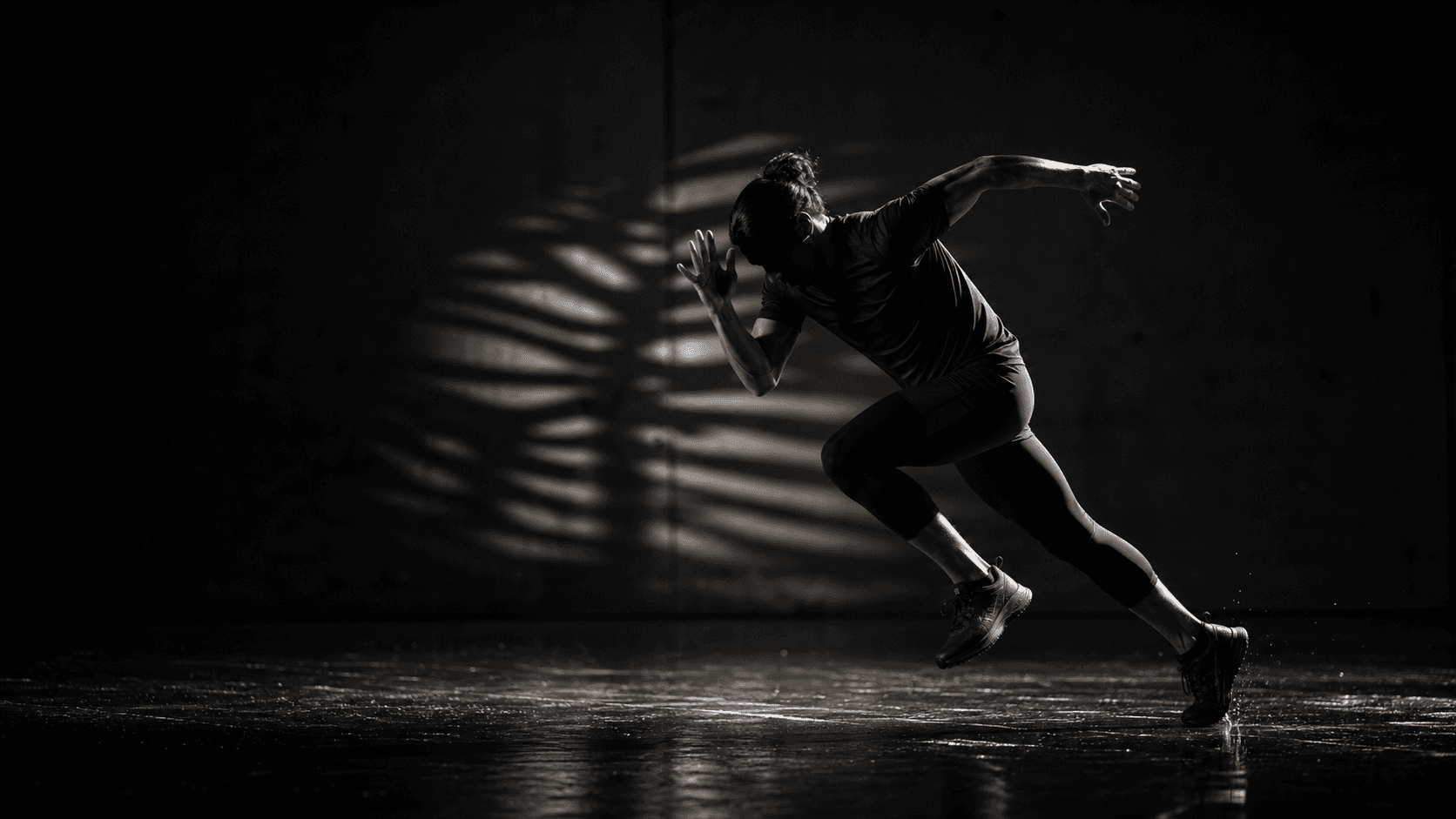 Atleta em movimento usando roupa técnica escura